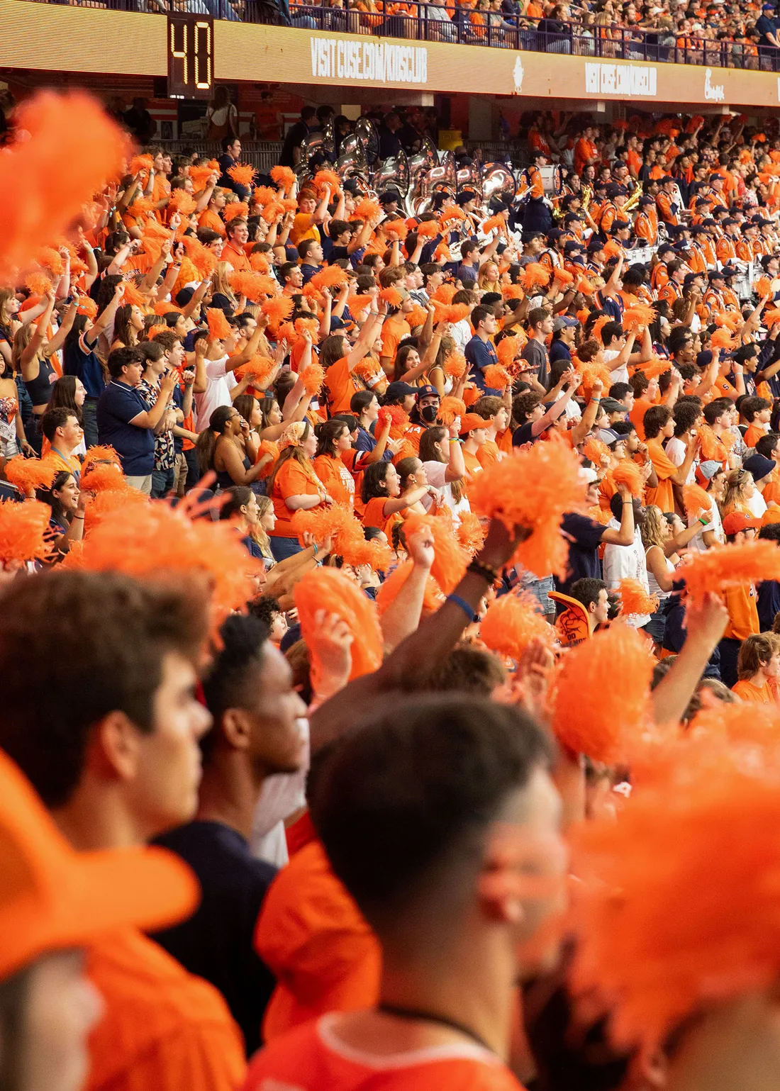 A crowd of Syracuse University students cheering at the JMA Wireless Dome at the Syracuse vs. Ohio State football game.