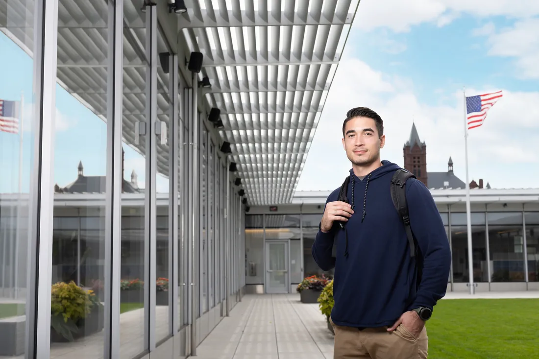 Student standing outside near the D'Aniello Institute for Veteran and Military Families building.