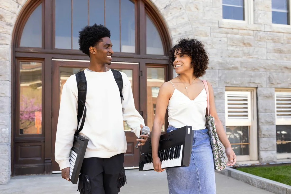 Brandon Porter and Marie-Elise Ambroise walking outisde Steele Hall.