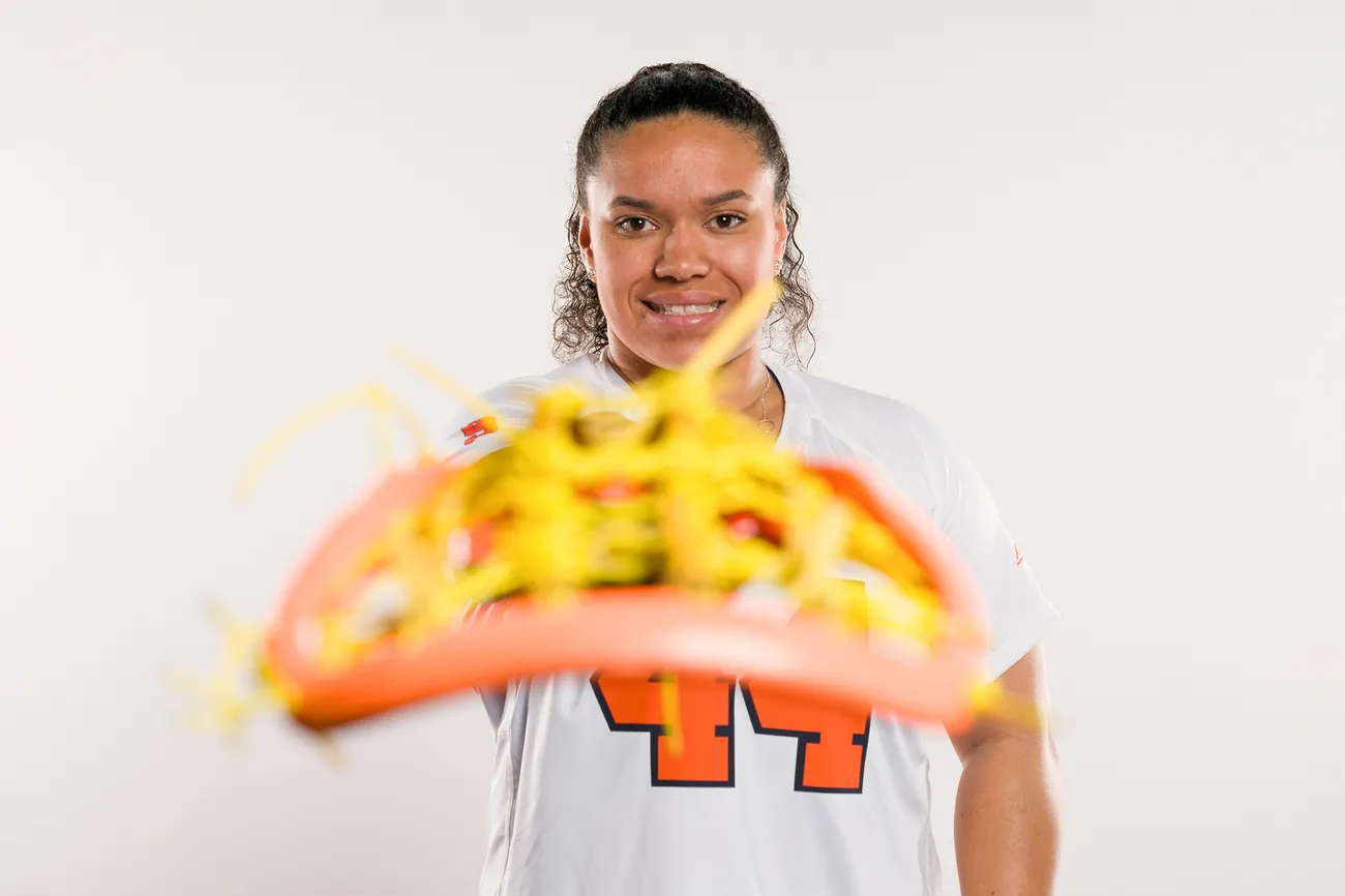 Person holding lacrosse stick.