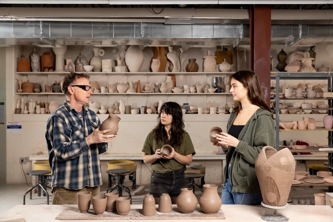 Errol Willett is teaching students in his Ceramics studio.