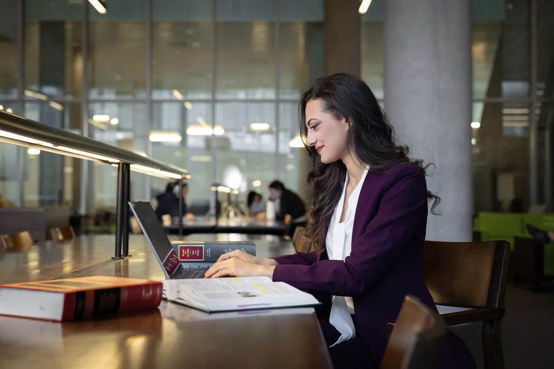 Law student Omnia Shedid doing work in the College of Law Library.