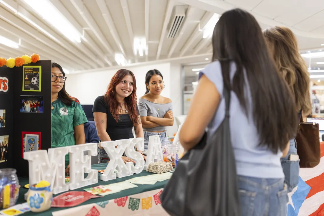 Students speaking at a Welcome Week student organizations involvement fair.