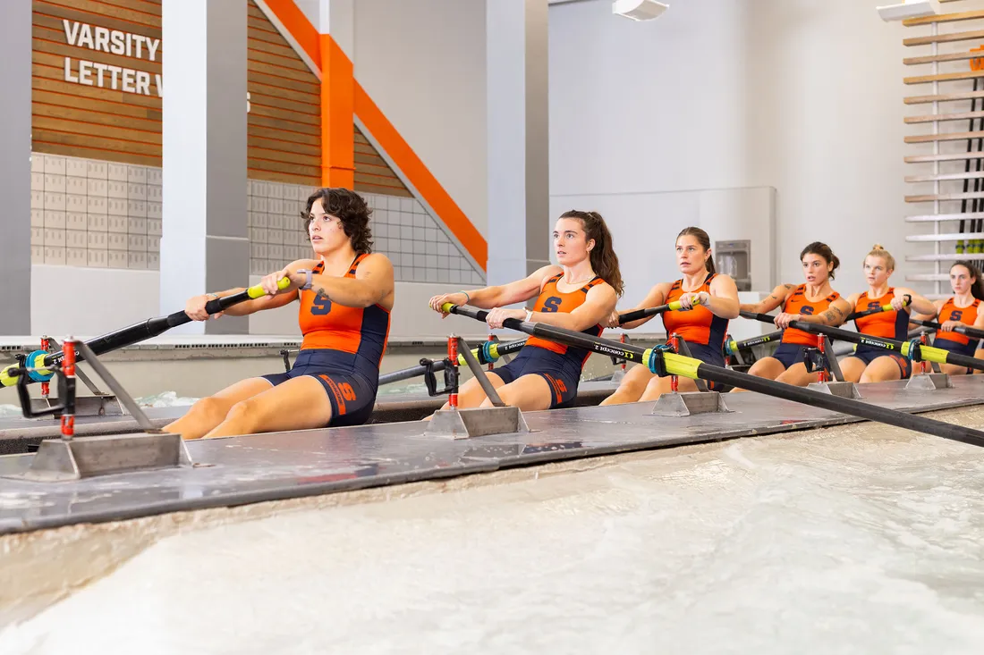 Women's rowing team practicing indoors.