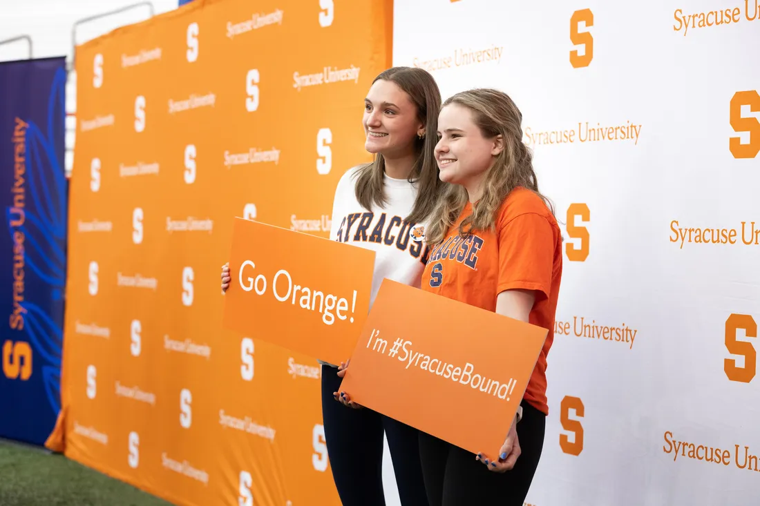 Two students smiling at spring reception.
