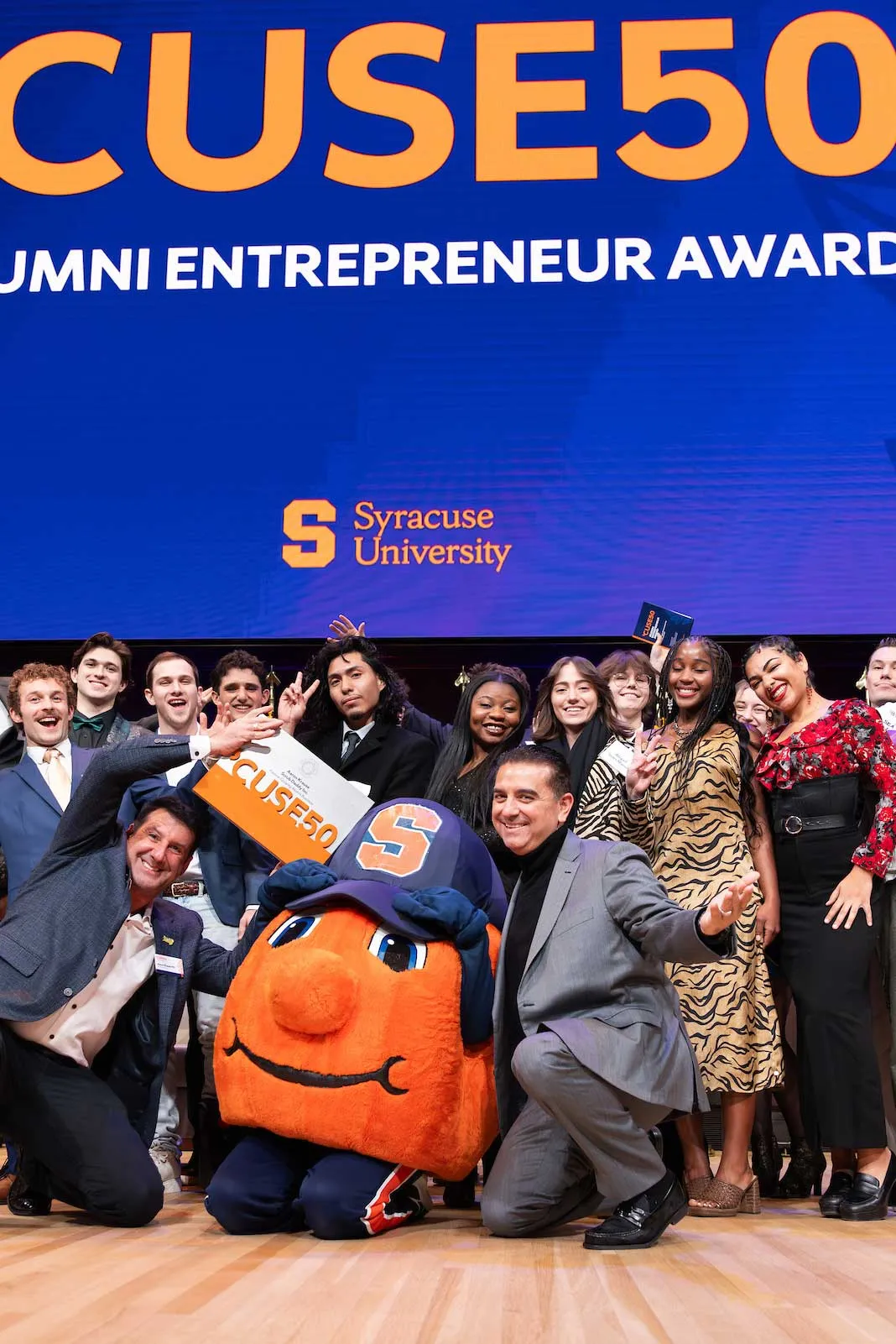 A group of people on a stage getting CUSE50 awards.