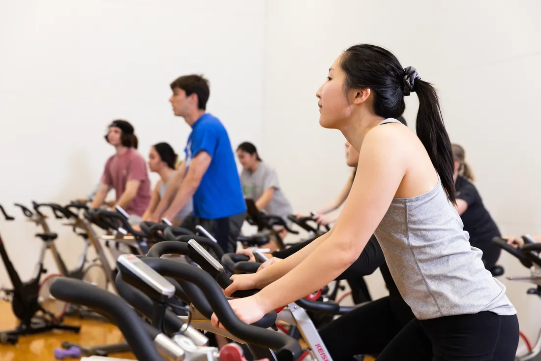 Students on stationary bicycles.