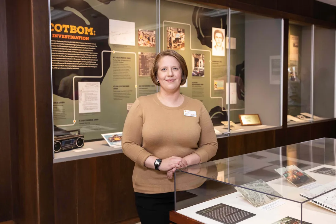 Researcher standing next to exhibit.