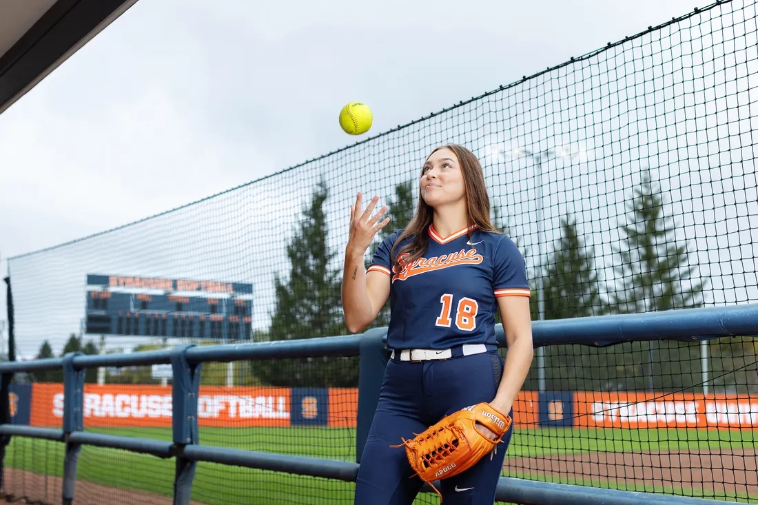 Olivia Pess throwing a softball.