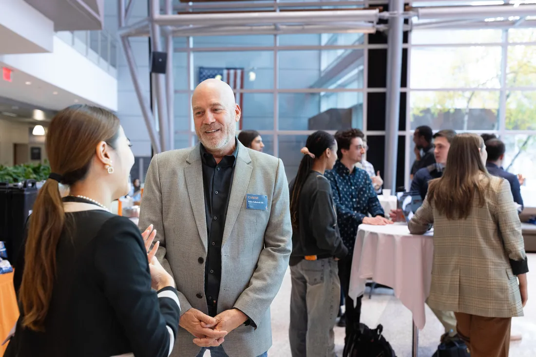 A student with an alum at a networking event.