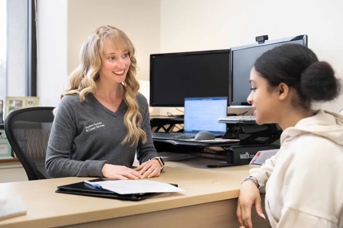 Career services staff member helping a student.