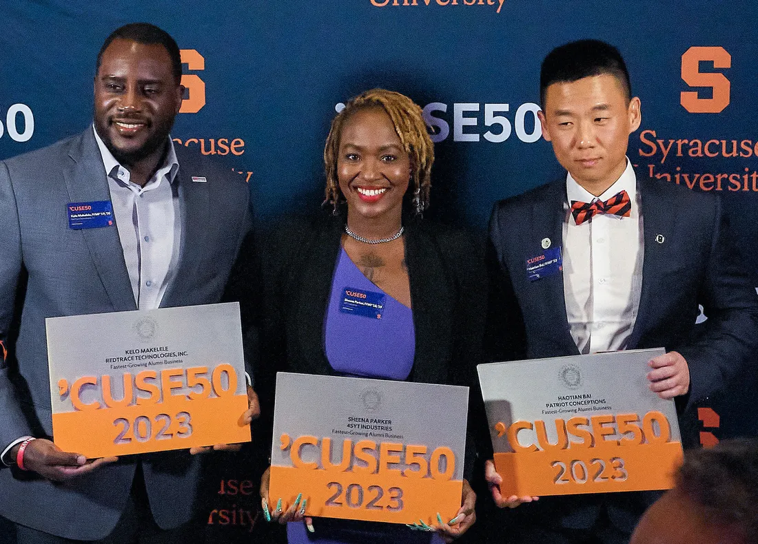 Alumni smiling with awards at the Alumni Entrepreneur Awards.