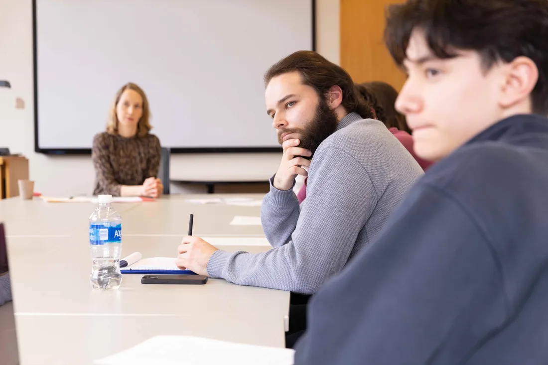 Students sitting at a table in a classroom.