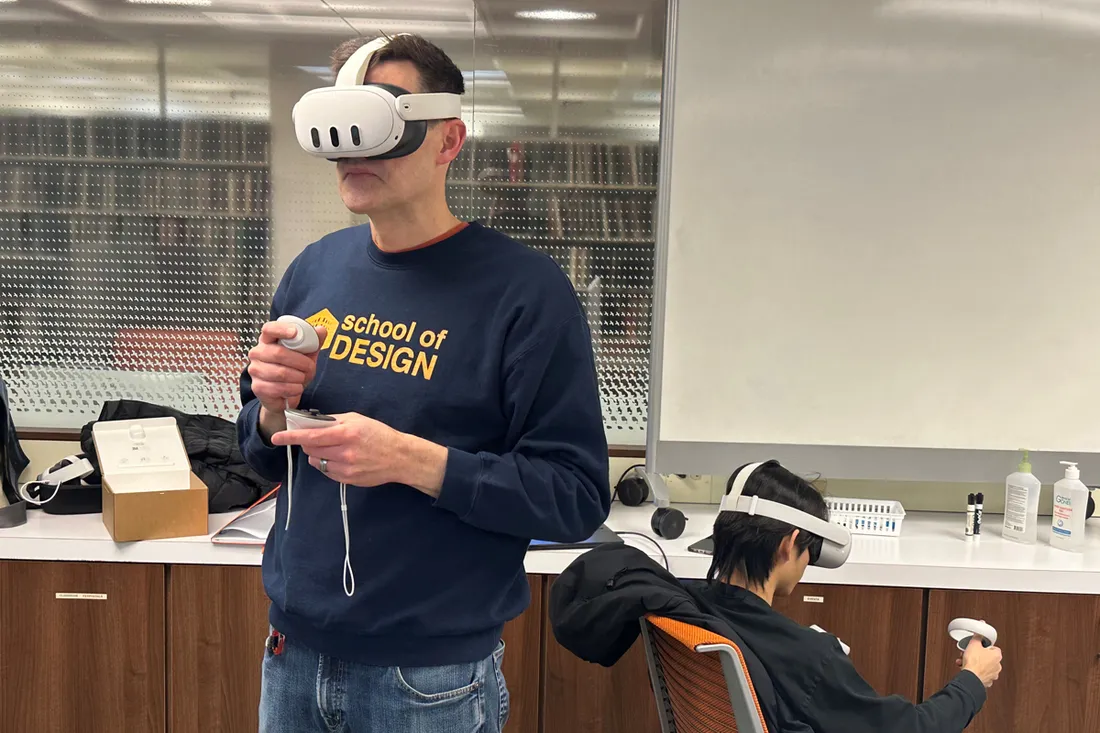 A student with a VR headset on in a classroom.