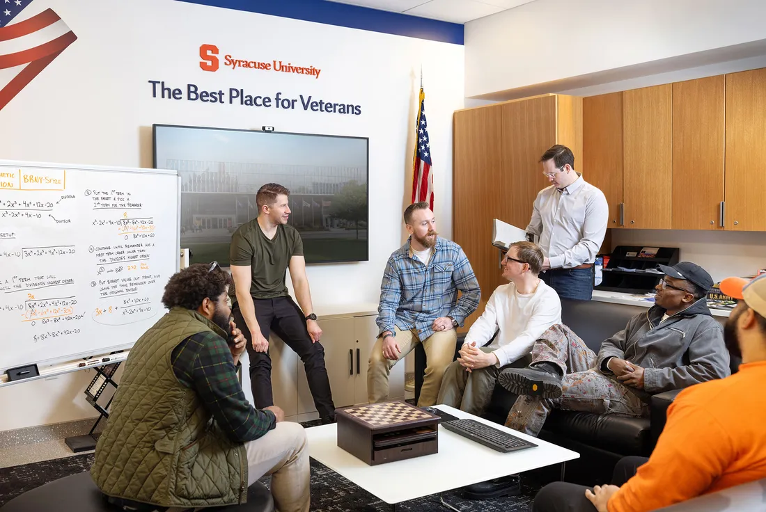 a group of military-connected students talking to each other.