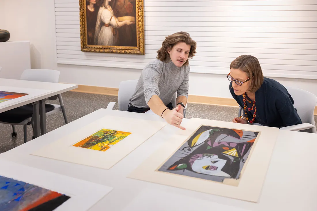 a student and professor performing a museum review together.