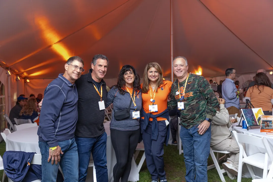 Alumni during Orange Central standing together.