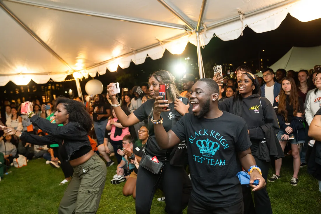 Students smiling and laughing at a Syracuse Welcome event.